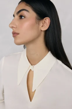 Blusa plumas puño